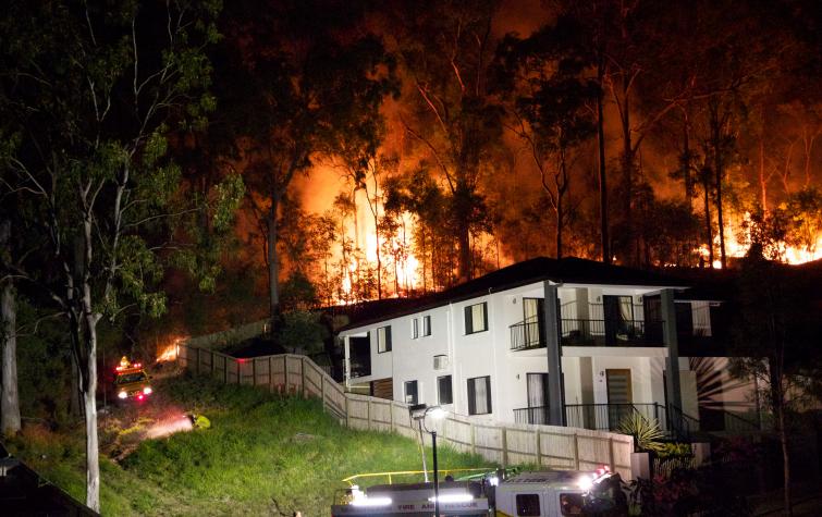 A bushfire rages behind a Brisbane home. Photo: HighExposure (CC BY-NC-ND-2.0)