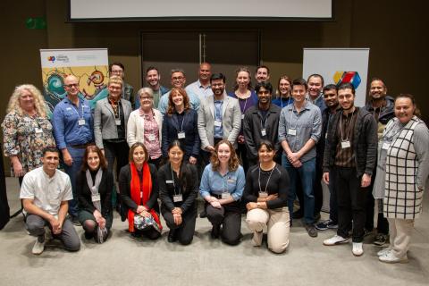 Group of people gathered together smiling at camera